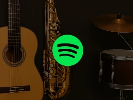 تصویری از لوگو اسپاتیفای در کنار چند گیتار